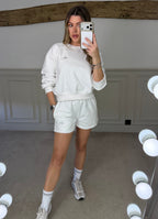 White jumper and shorts co-ord worn front on