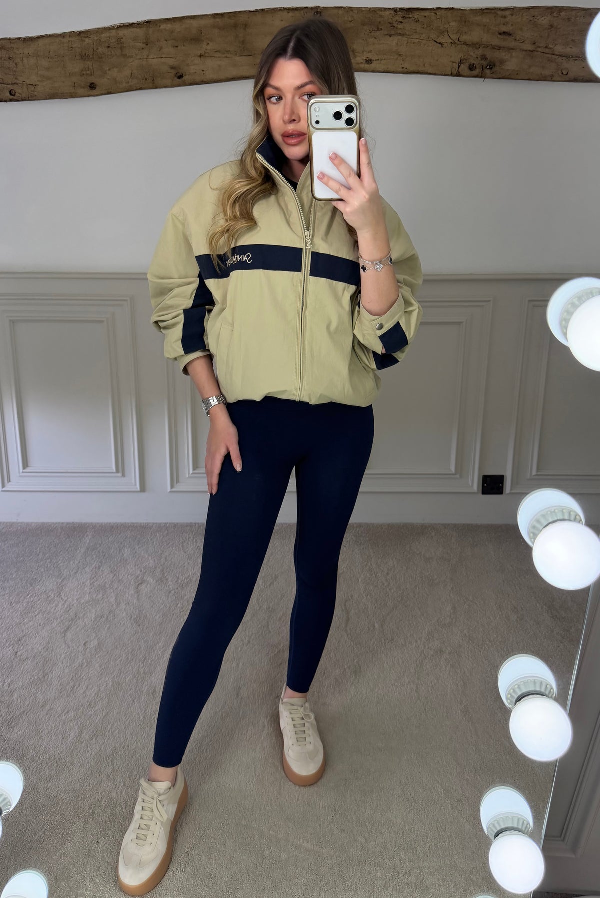 Beige and navy canvas zip up track jacket worn open