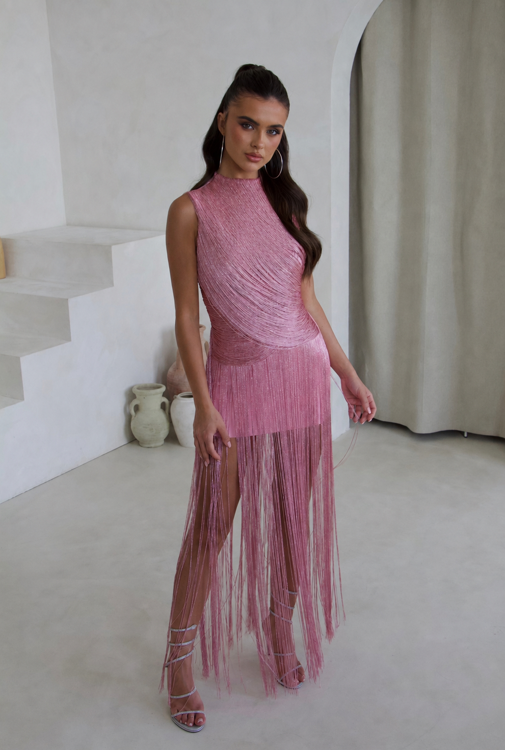 Model wearing the SWAY pink tassel fringe bandage dress, front view