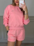 Pink jumper and shorts co-ord worn front on