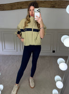 Beige and navy track jacket shown from the back