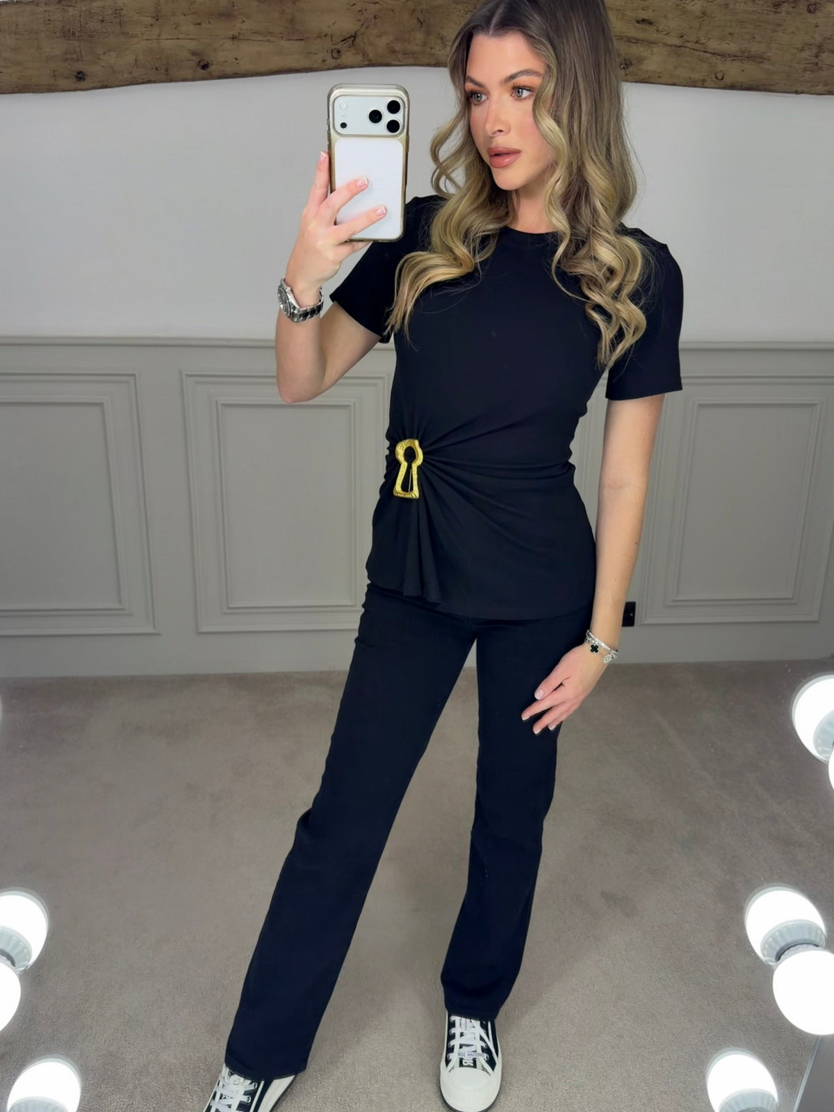 Black t-shirt with gold keyhole worn front on