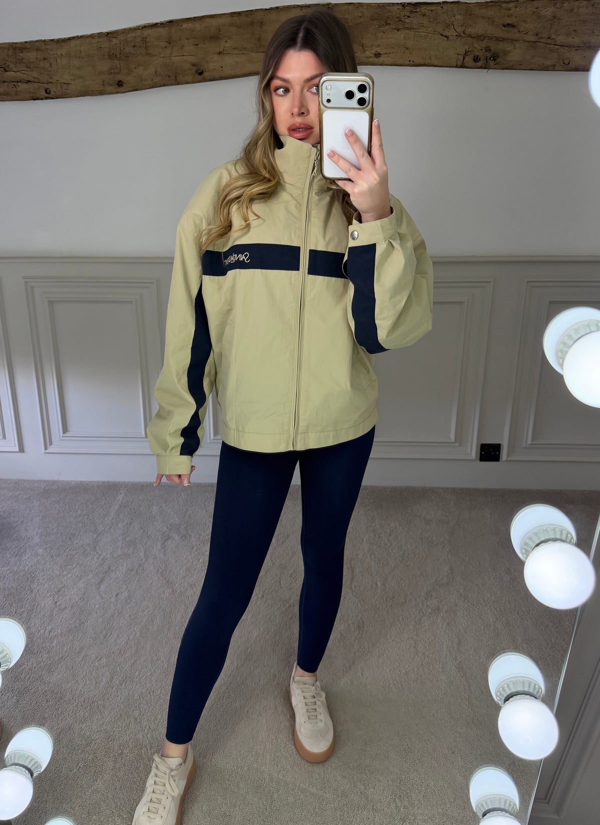 Side view of the canvas beige and navy zip up jacket