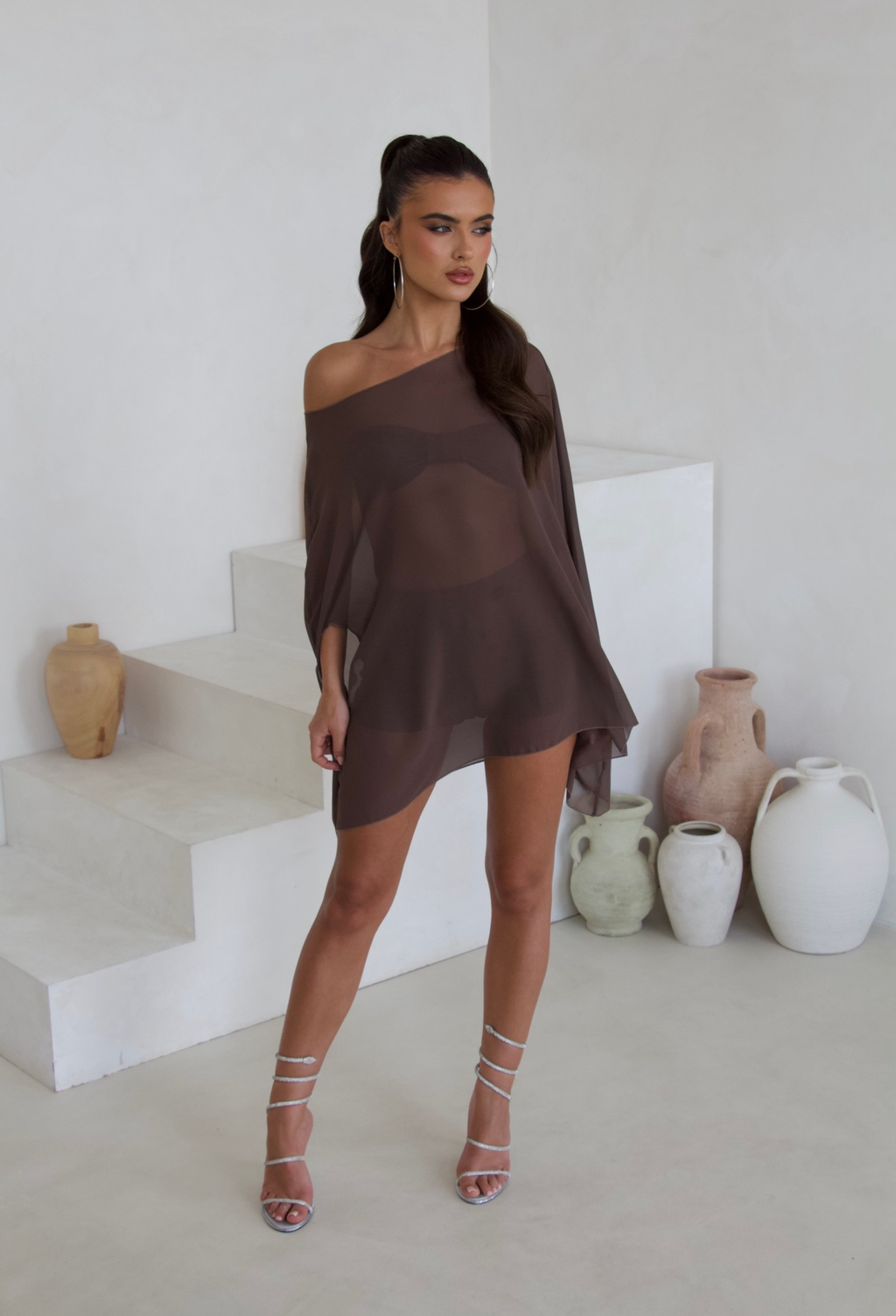 Model wearing the brown cape three piece bandeau and shorts set, front view