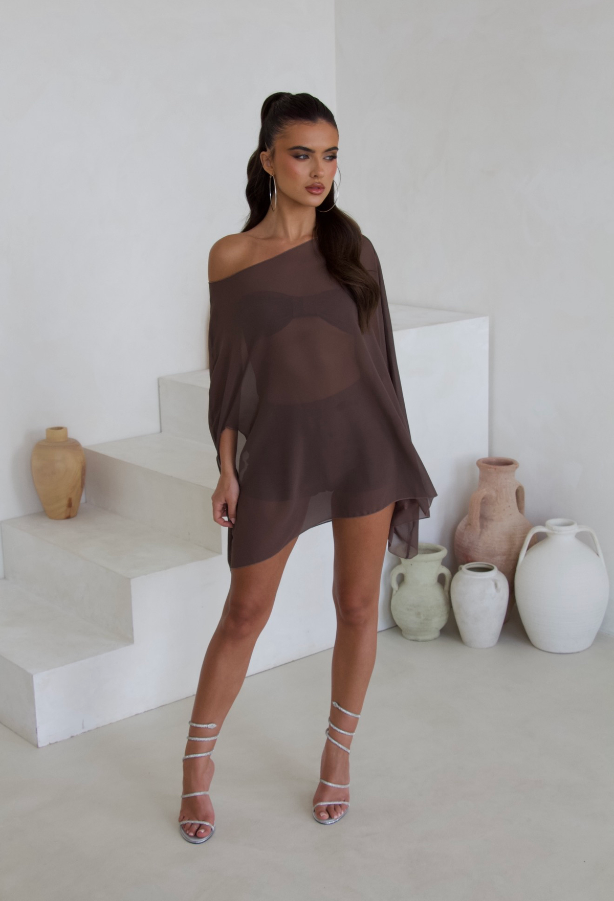 Model wearing the brown cape three piece bandeau and shorts set, front view