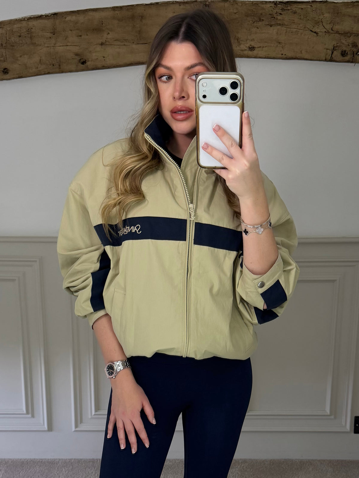 Front view of the beige and navy canvas track jacket