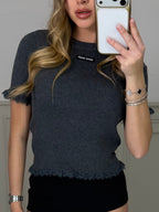 Grey knitted top with frill trim worn front on
